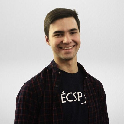 Dmytro has dark short hair and a big smile.